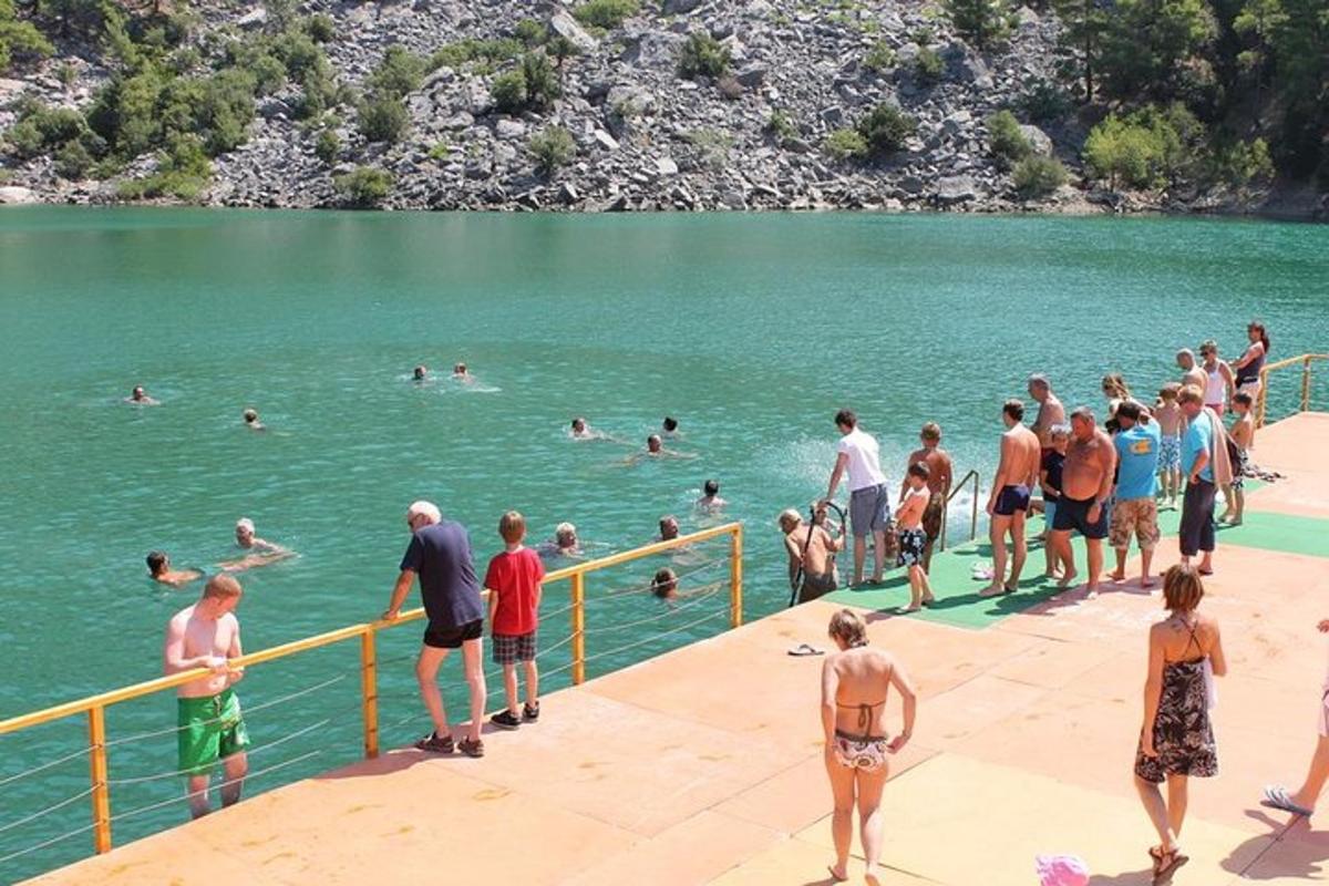 a group of people in the water at a lake