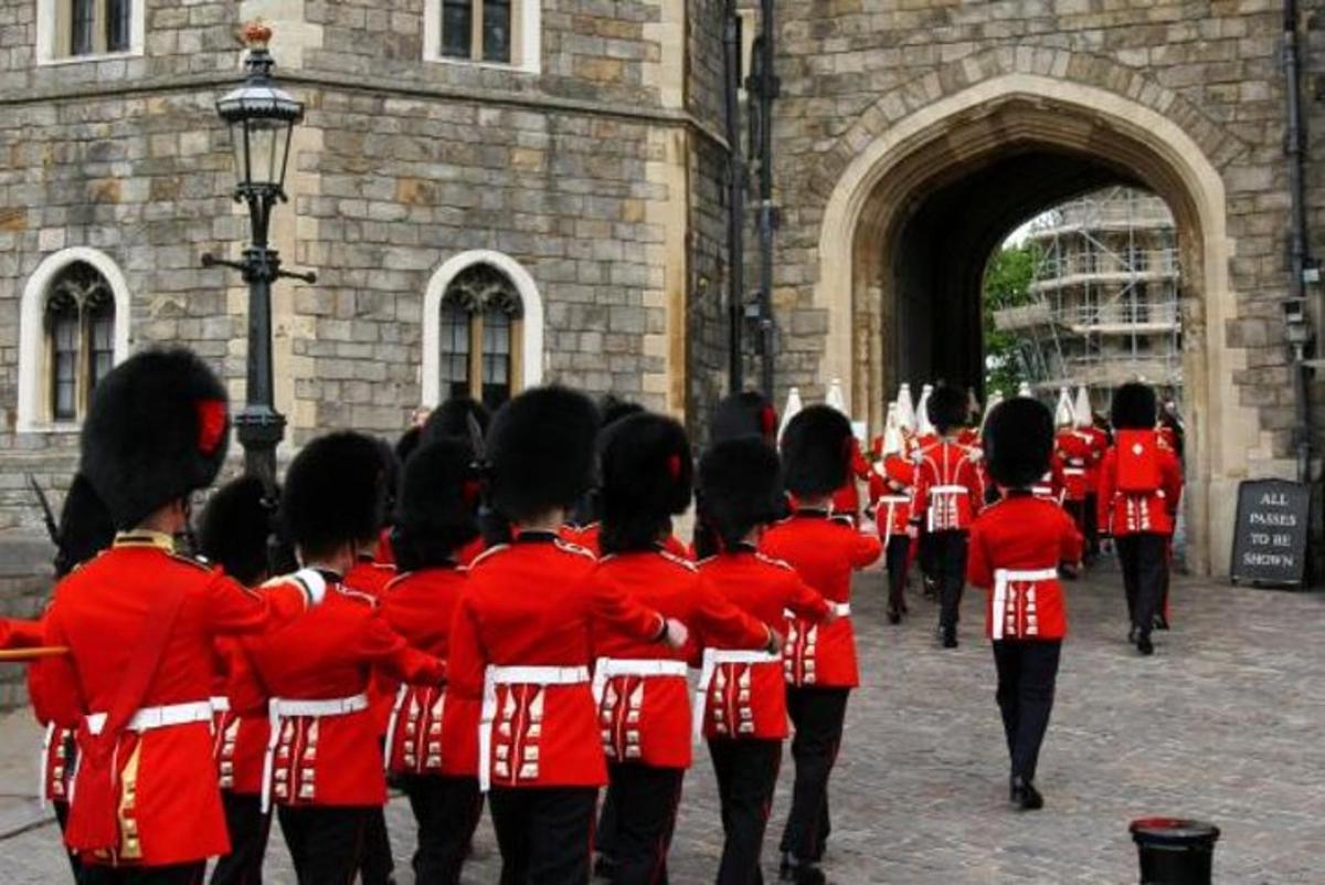 a group of women in red uniforms standing in front of a building