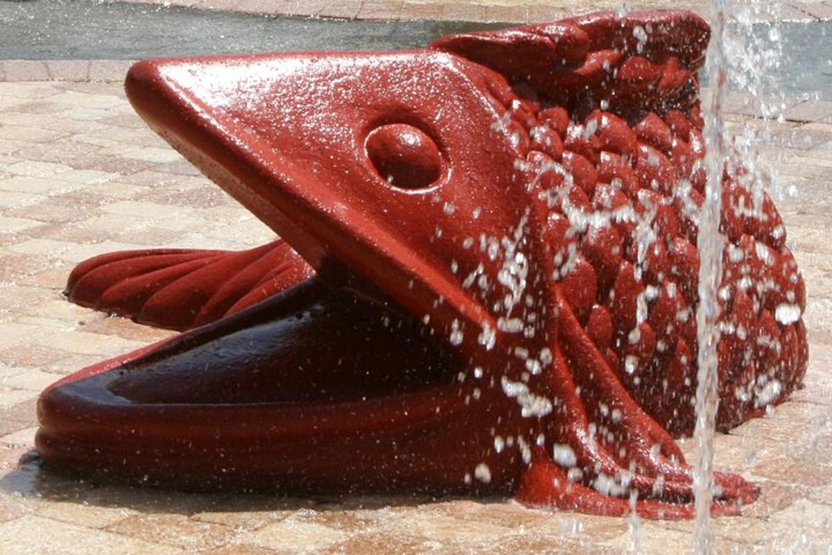 a close up of a bird fountain with water coming out