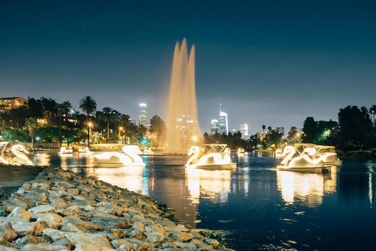 a fountain in the water with a city in the background