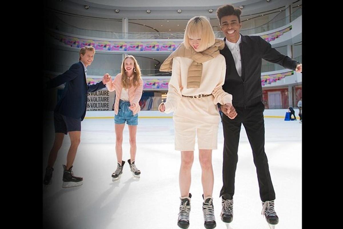 a group of people skating on an ice rink