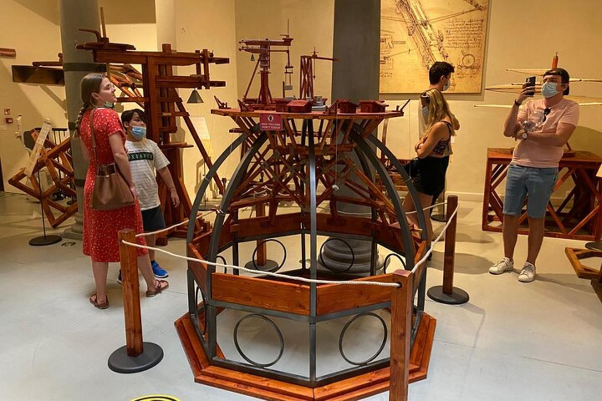 a group of people looking at a wooden boat in a museum
