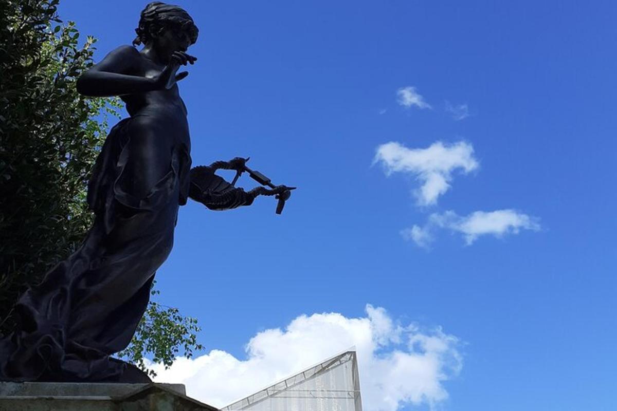 a statue of a woman holding a wand