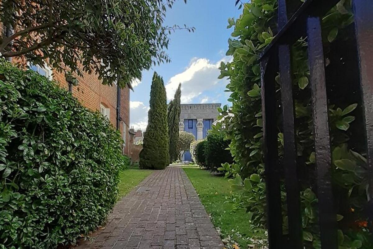 a gate to a house with a brick pathway