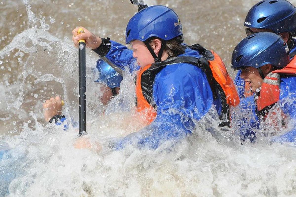 a group of people in a raft in the water