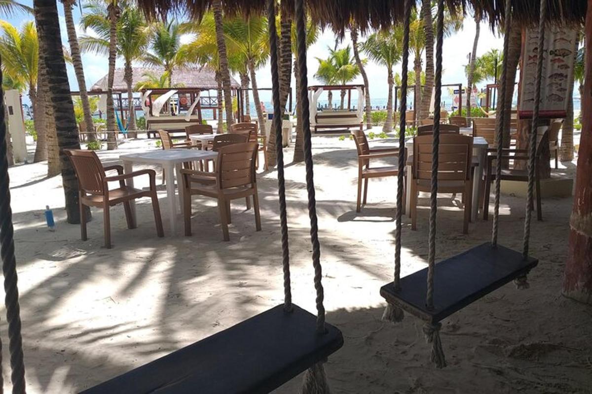 a patio with a table and chairs and palm trees