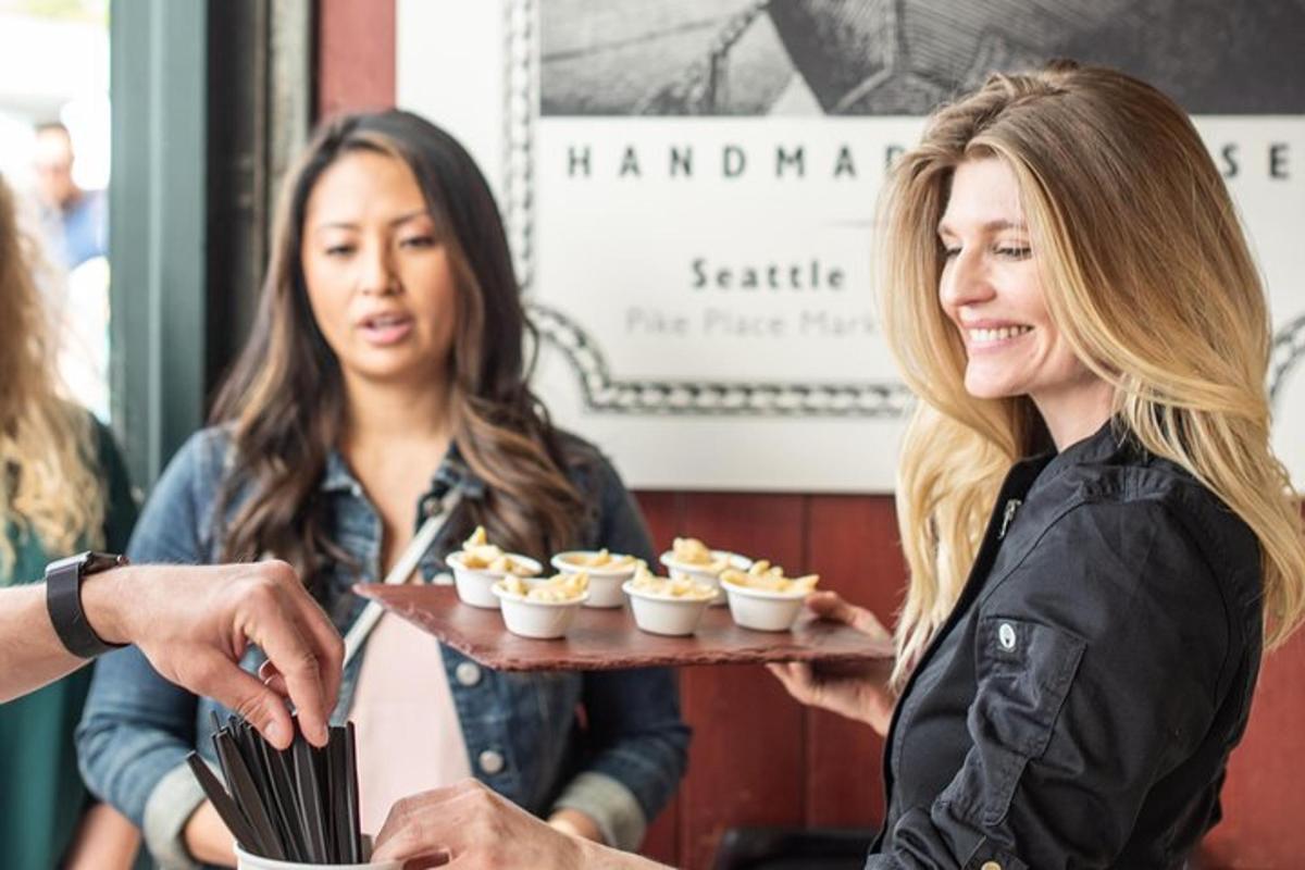 a woman holding a tray of cupcakes