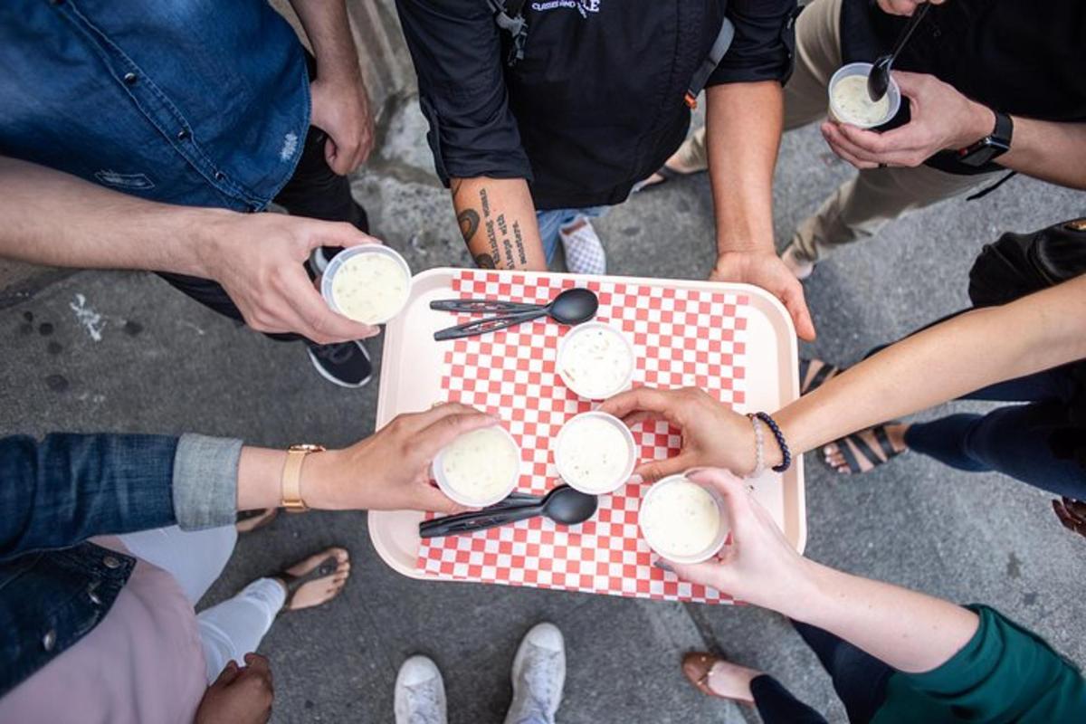 a group of people standing around a table with drinks