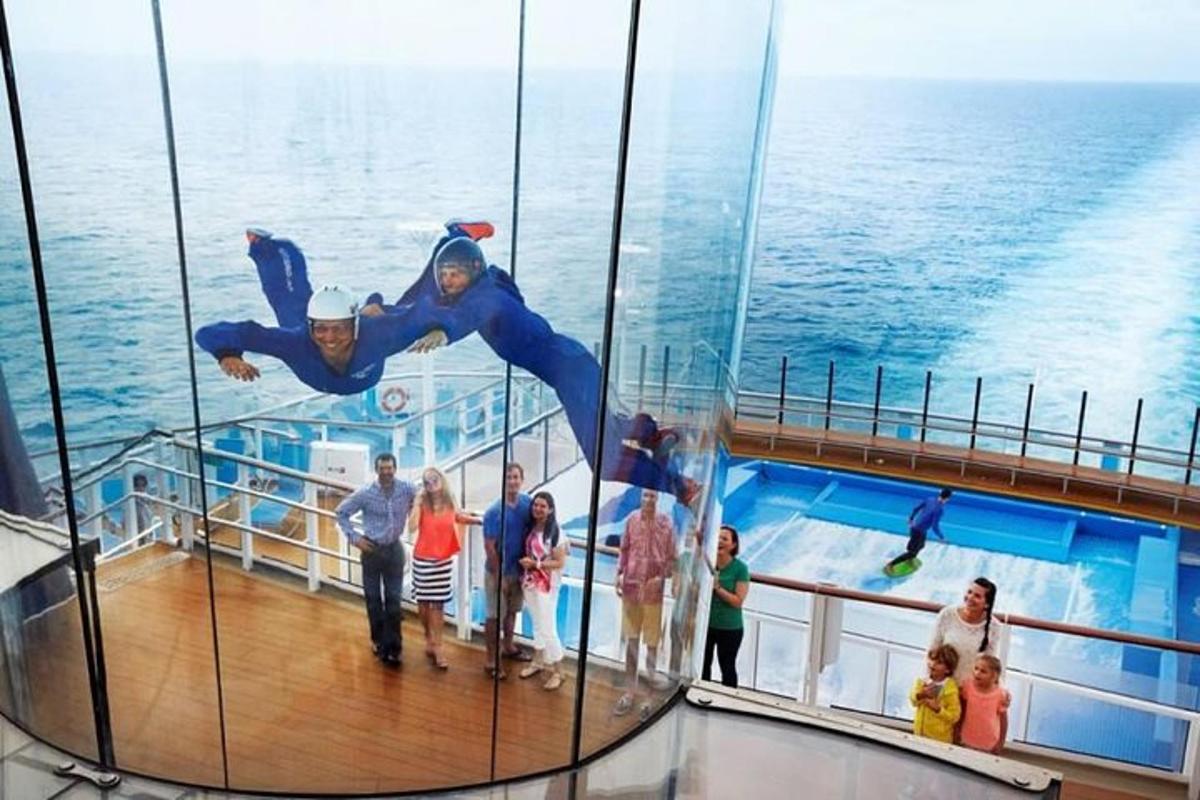 a group of people standing on the deck of a cruise ship