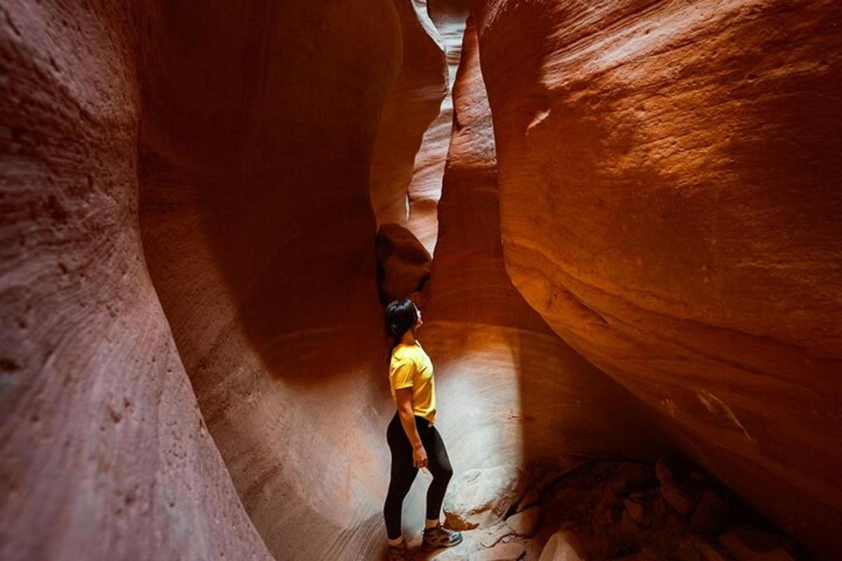 a man is standing in a slot canyon