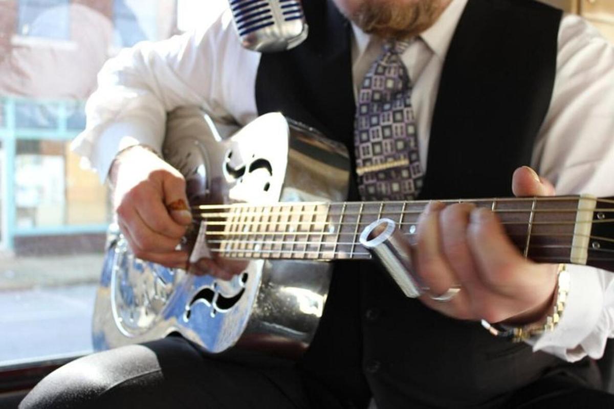 a man is playing a guitar with a microphone