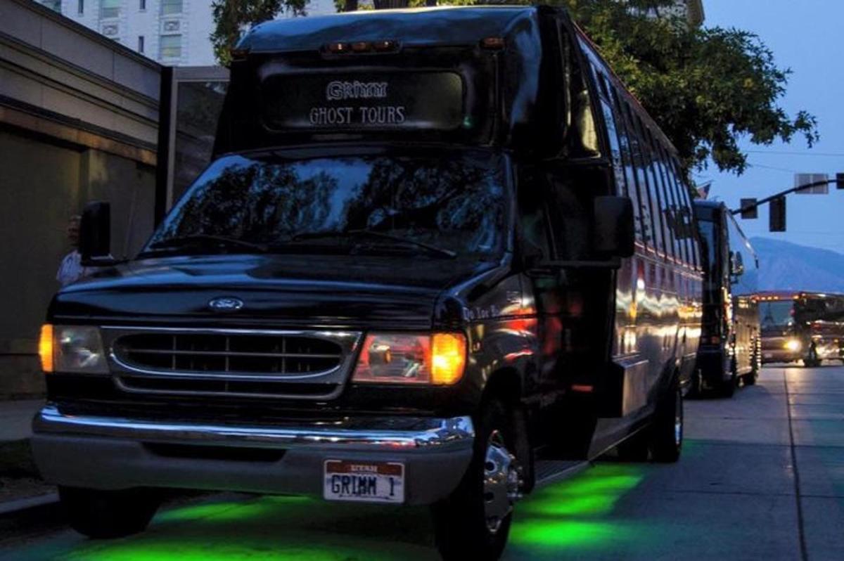a black bus parked on the side of a street