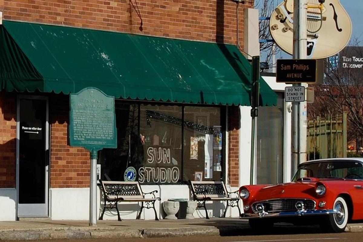 an old red car parked in front of a store