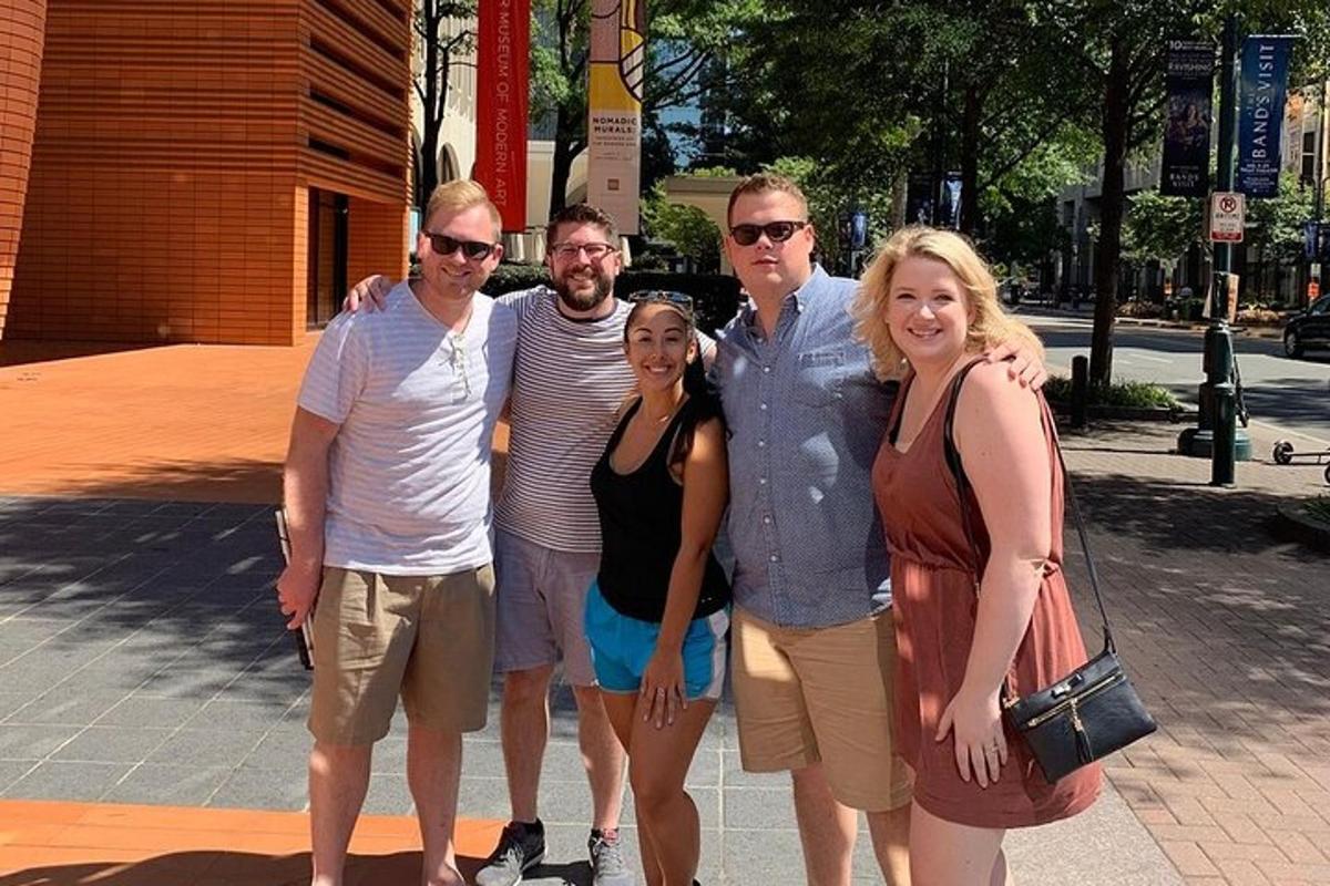 a group of people posing for a picture on the street