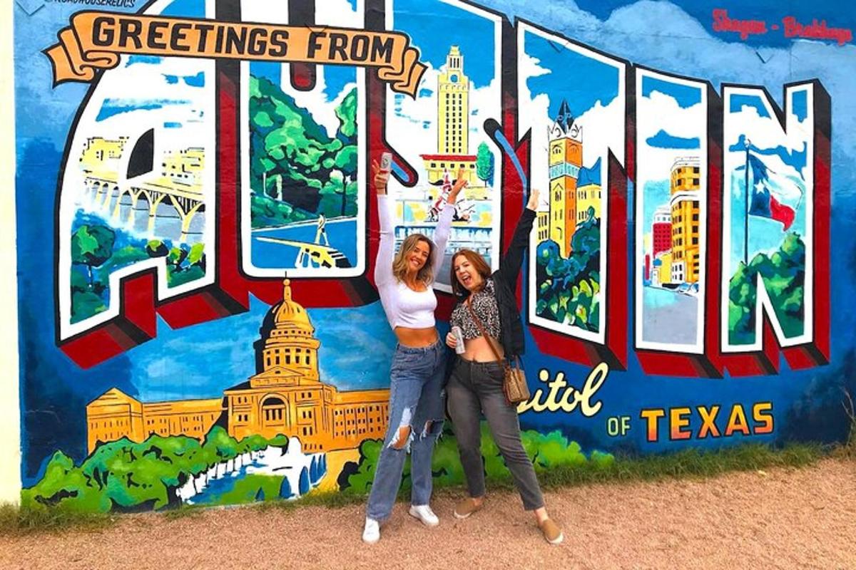 two women are standing in front of a mural