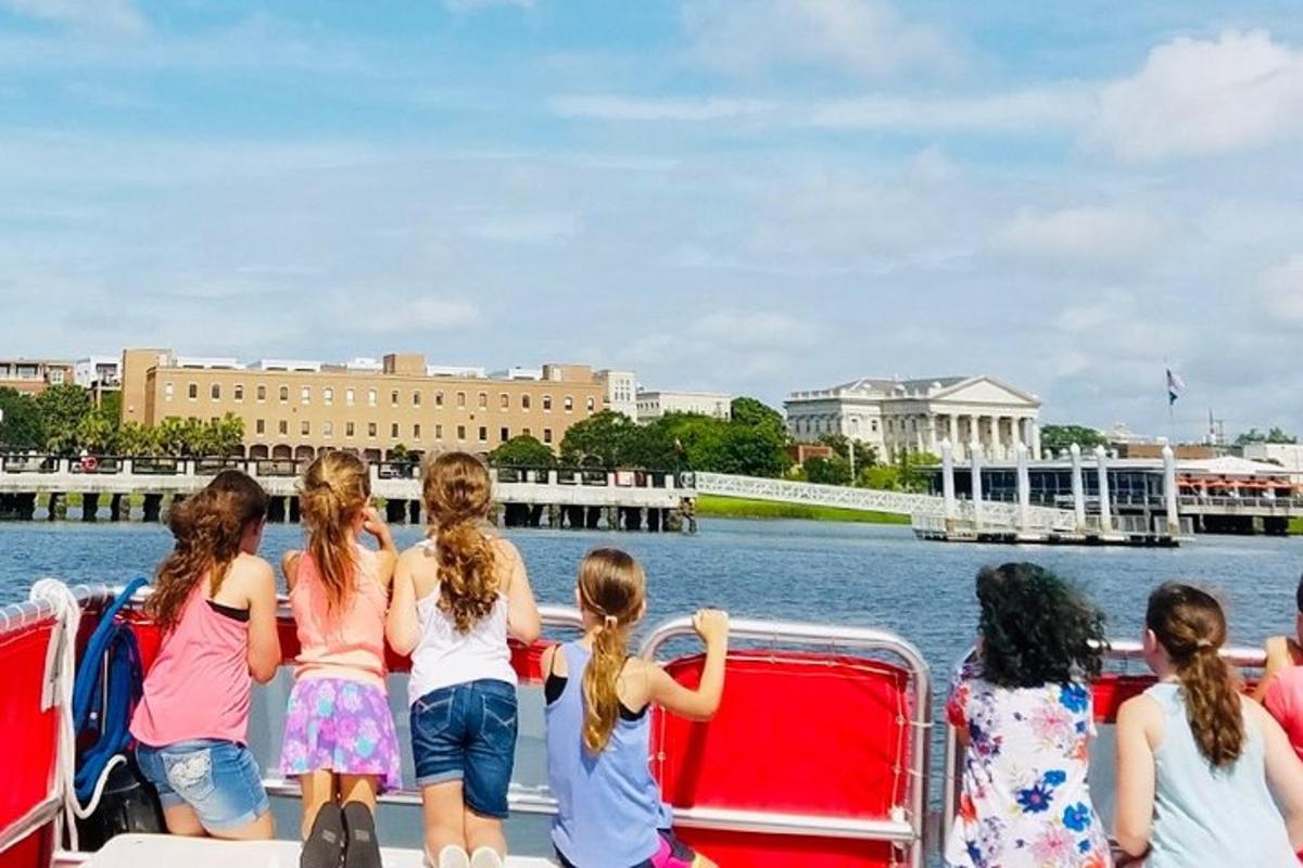 a group of children on a boat on the water