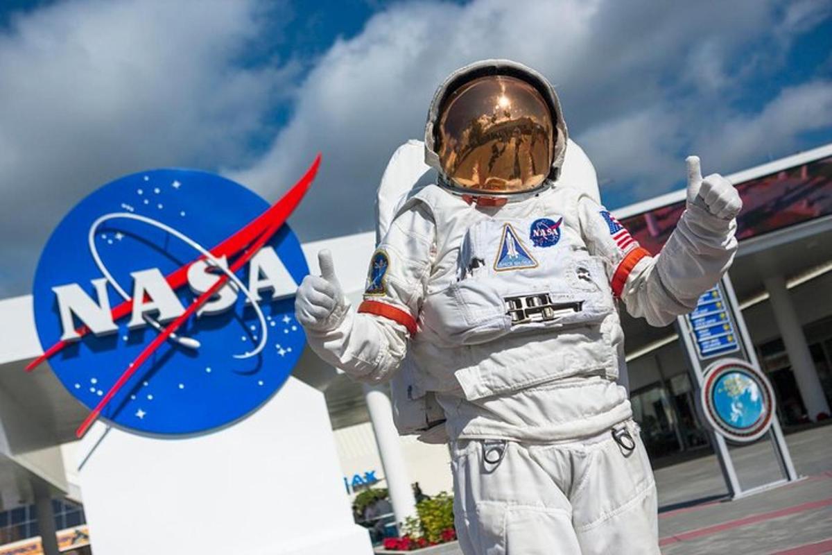 a man in an astronaut suit giving the thumbs up