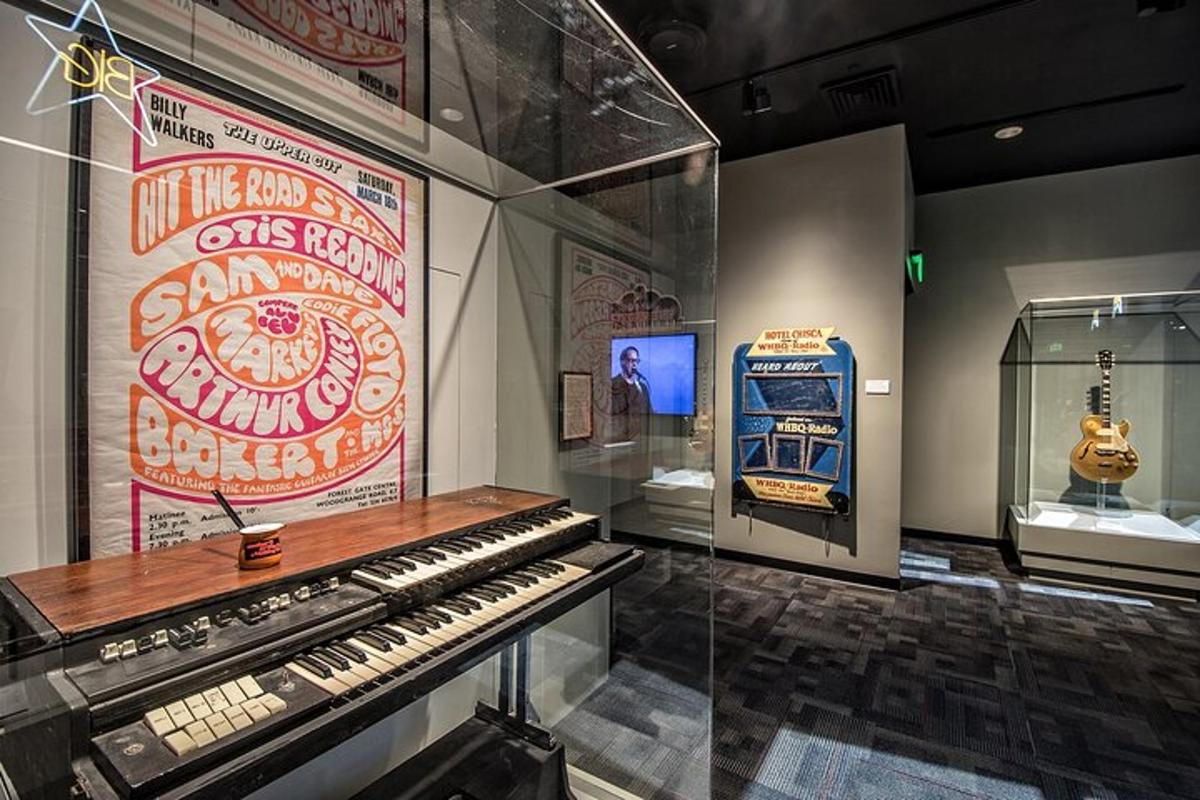 a museum with an old keyboard and a guitar on display