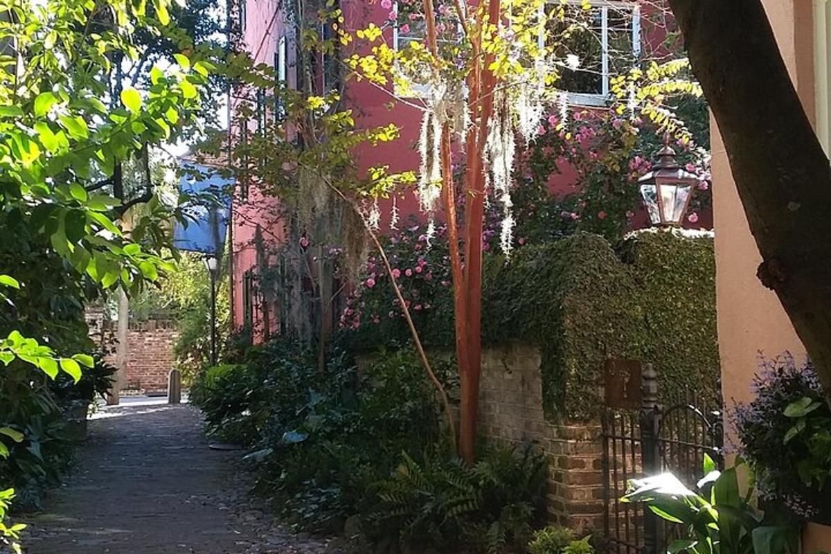 a walkway in front of a building with plants