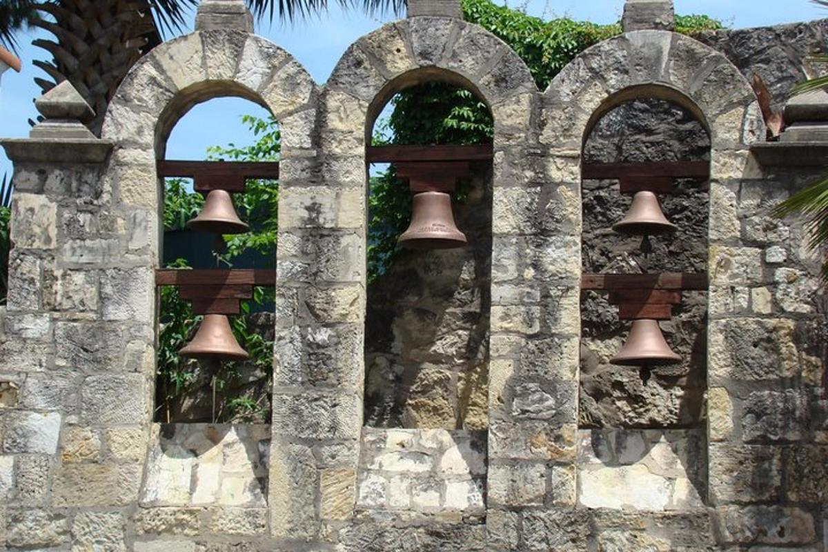 an old stone wall with bells on it