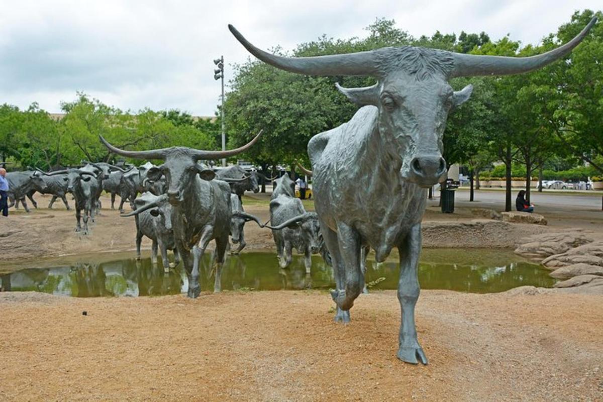 a statue of a bull standing in a field