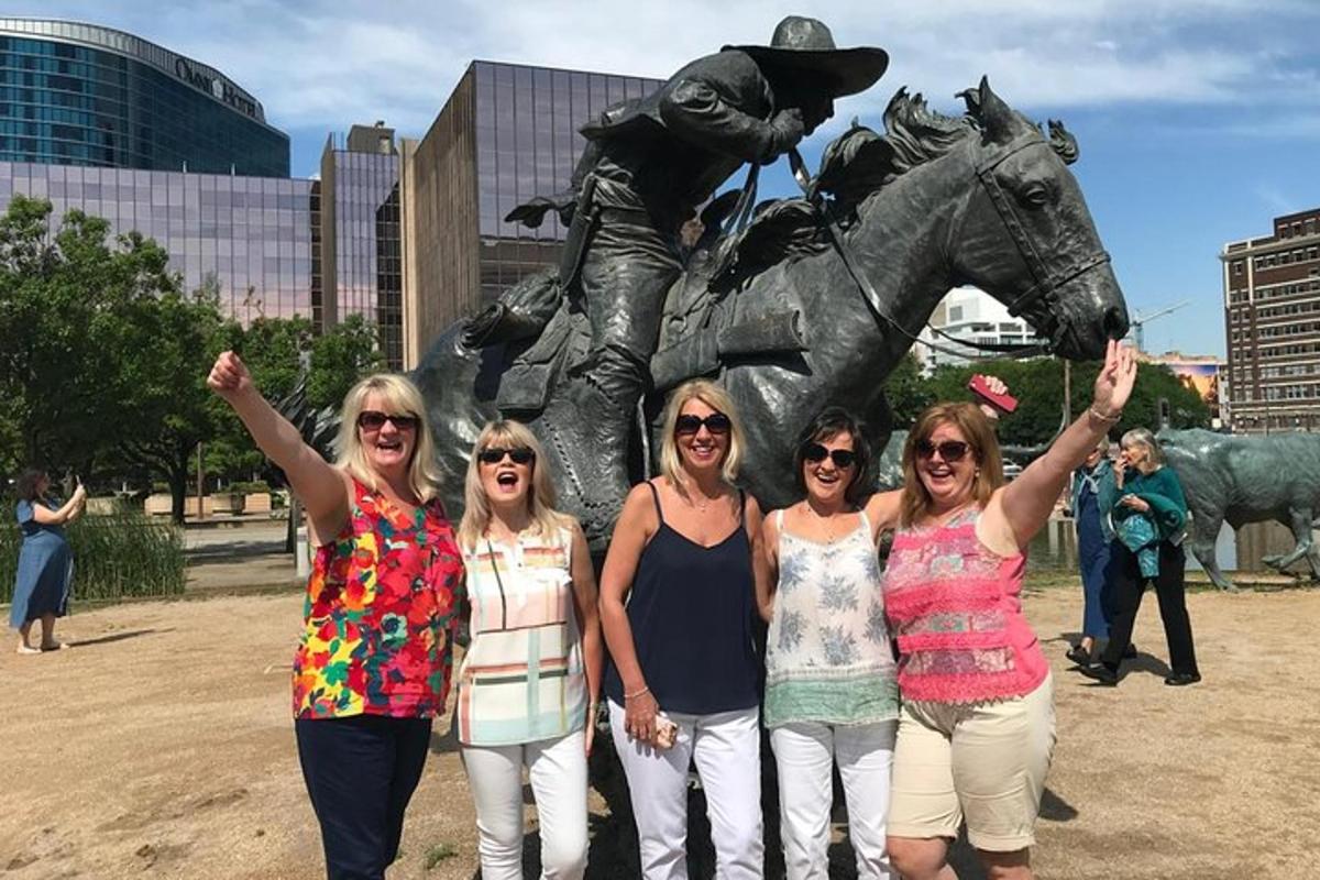 a group of women standing in front of a statue