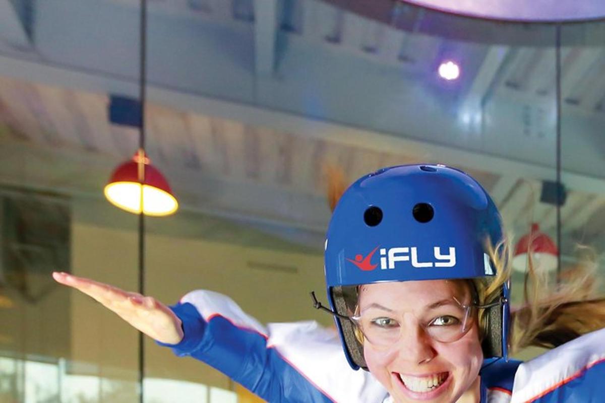 a woman wearing a helmet with her hand in the air