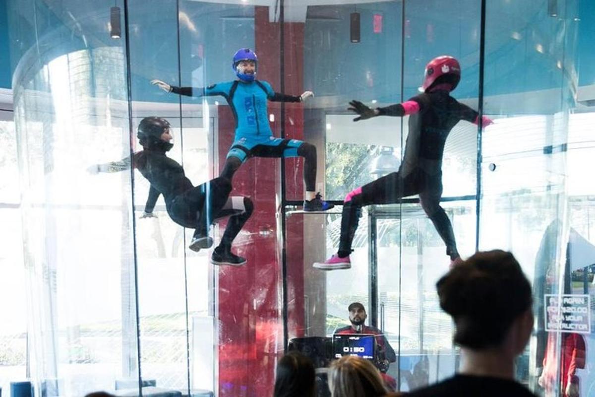 a group of people watching people on display in a room