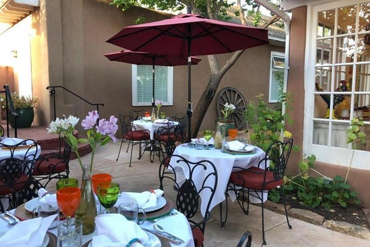 a group of tables with umbrellas on a patio