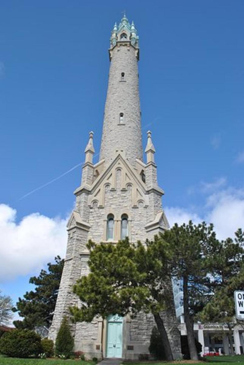 a tall tower with a tree in front of it