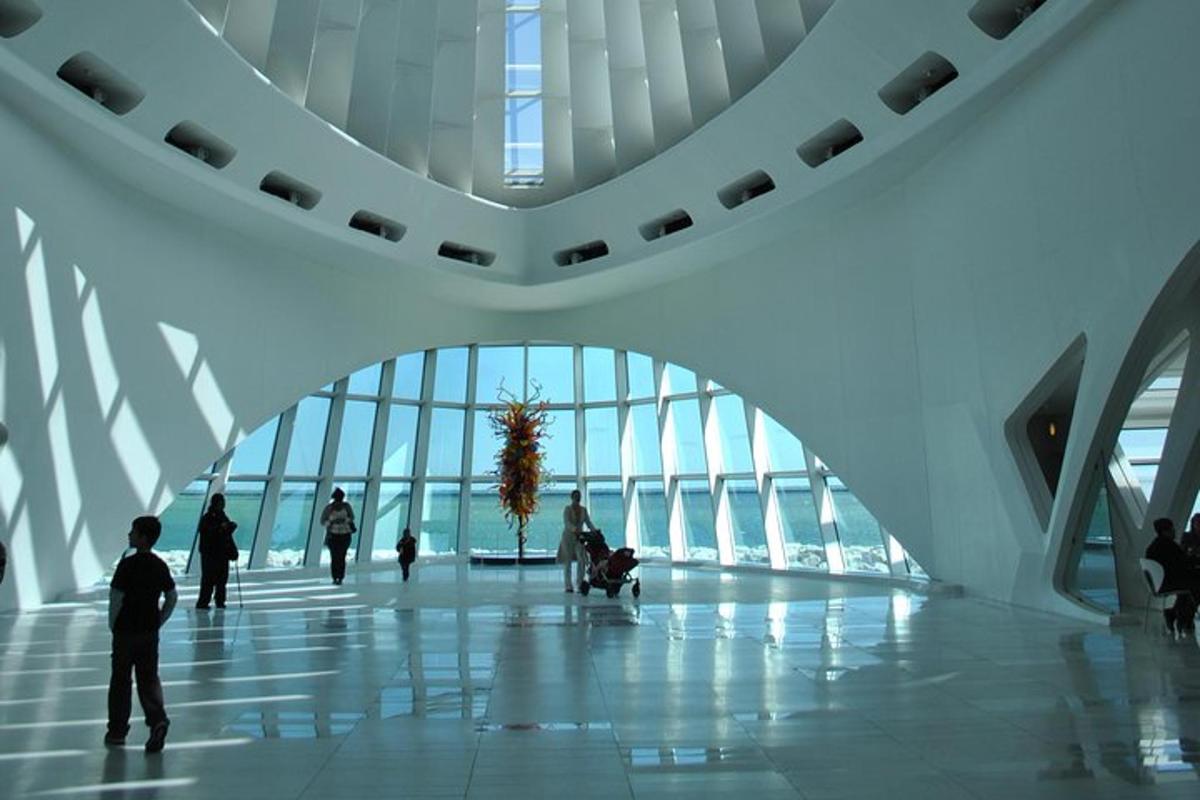people walking in a large building with a large window