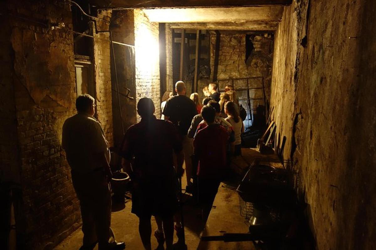 a group of people walking down a dark tunnel