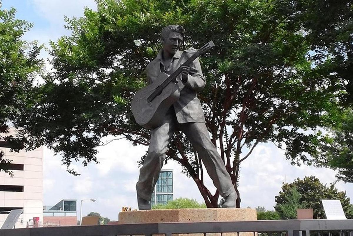 a statue of a man holding a guitar