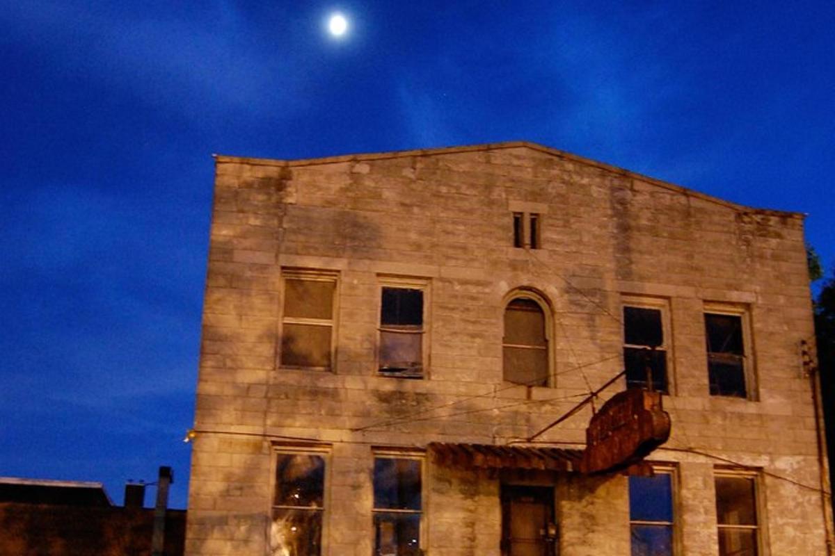 an old brick building with the moon in the sky