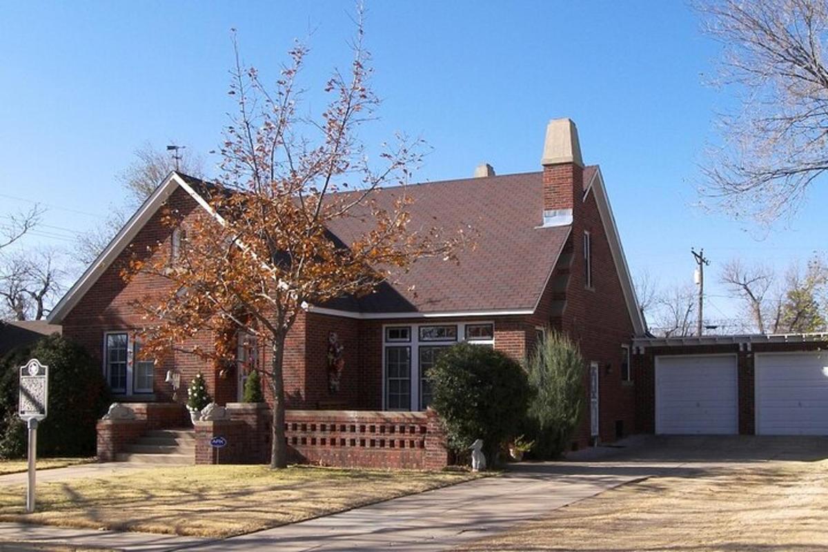 a red brick house with a white garage