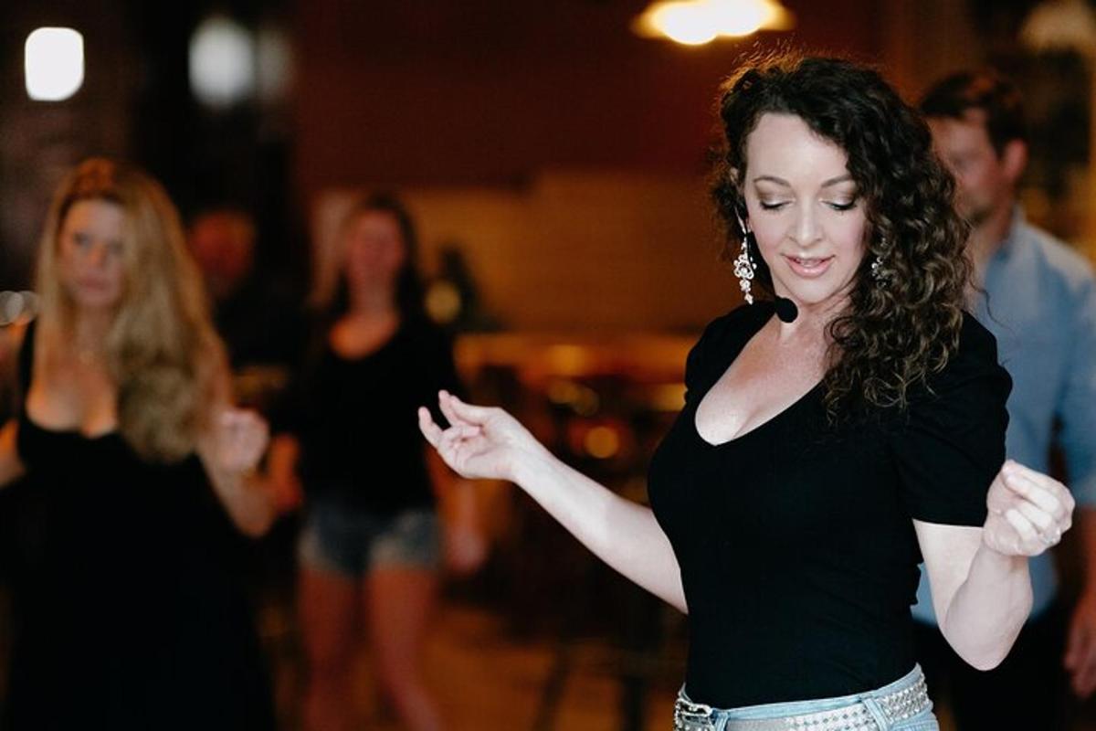 a woman in black shirt dancing on a dance floor