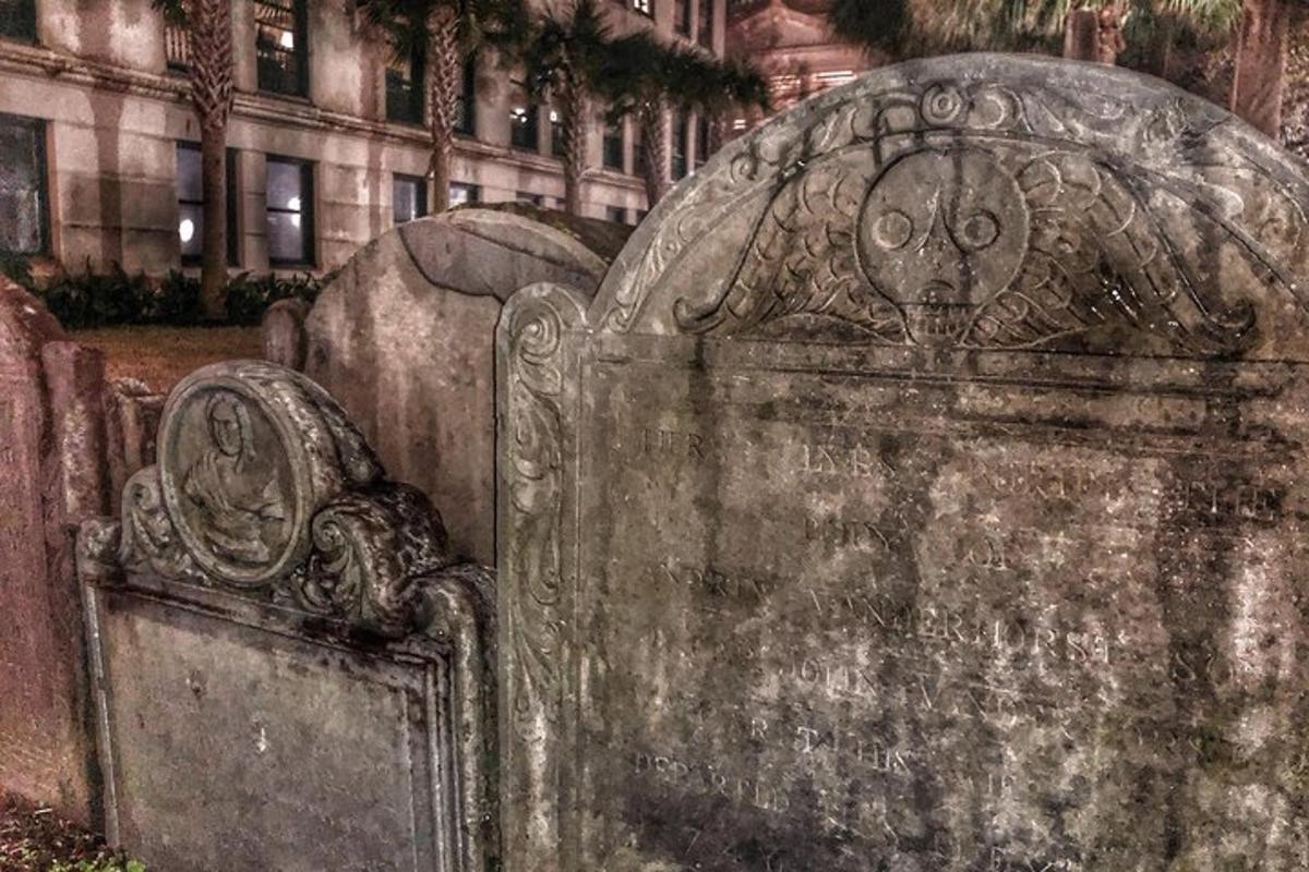 an old gravestone with a face on it in front of a building