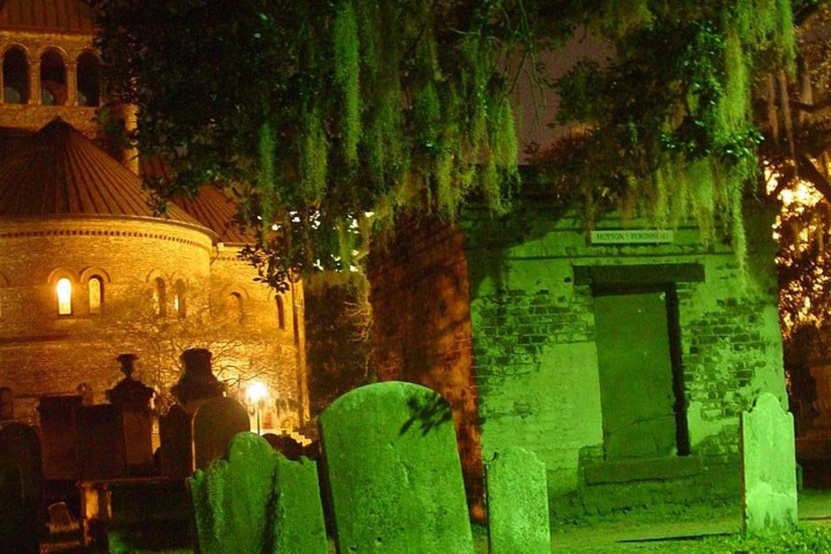 a cemetery with green lighting in front of a building