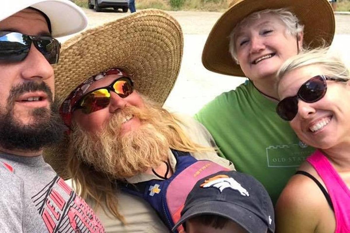a group of three people wearing hats and sunglasses