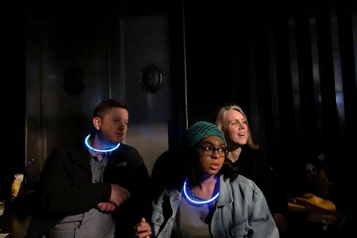 a group of people with led lights on their necks