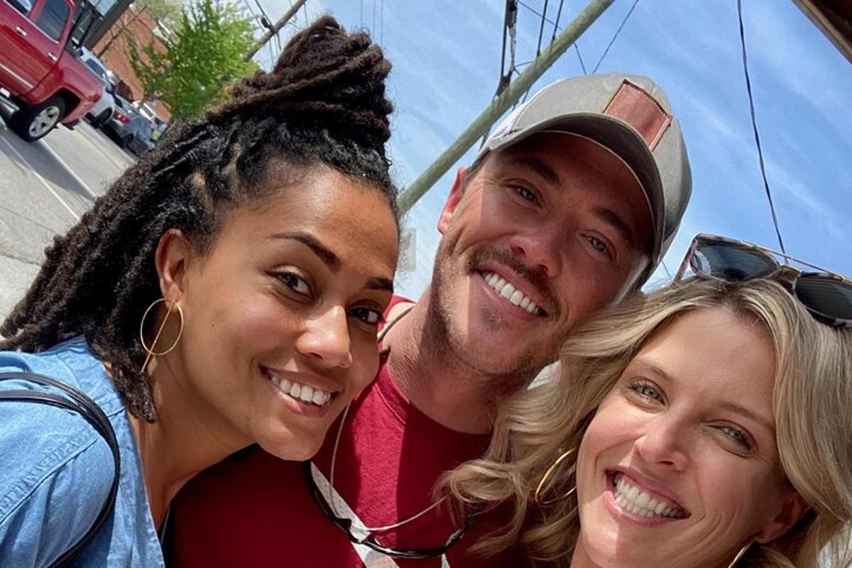 three people posing for a picture on a boat