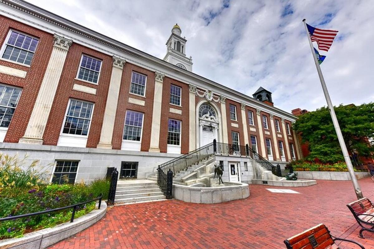 a large brick building with an american flag in front