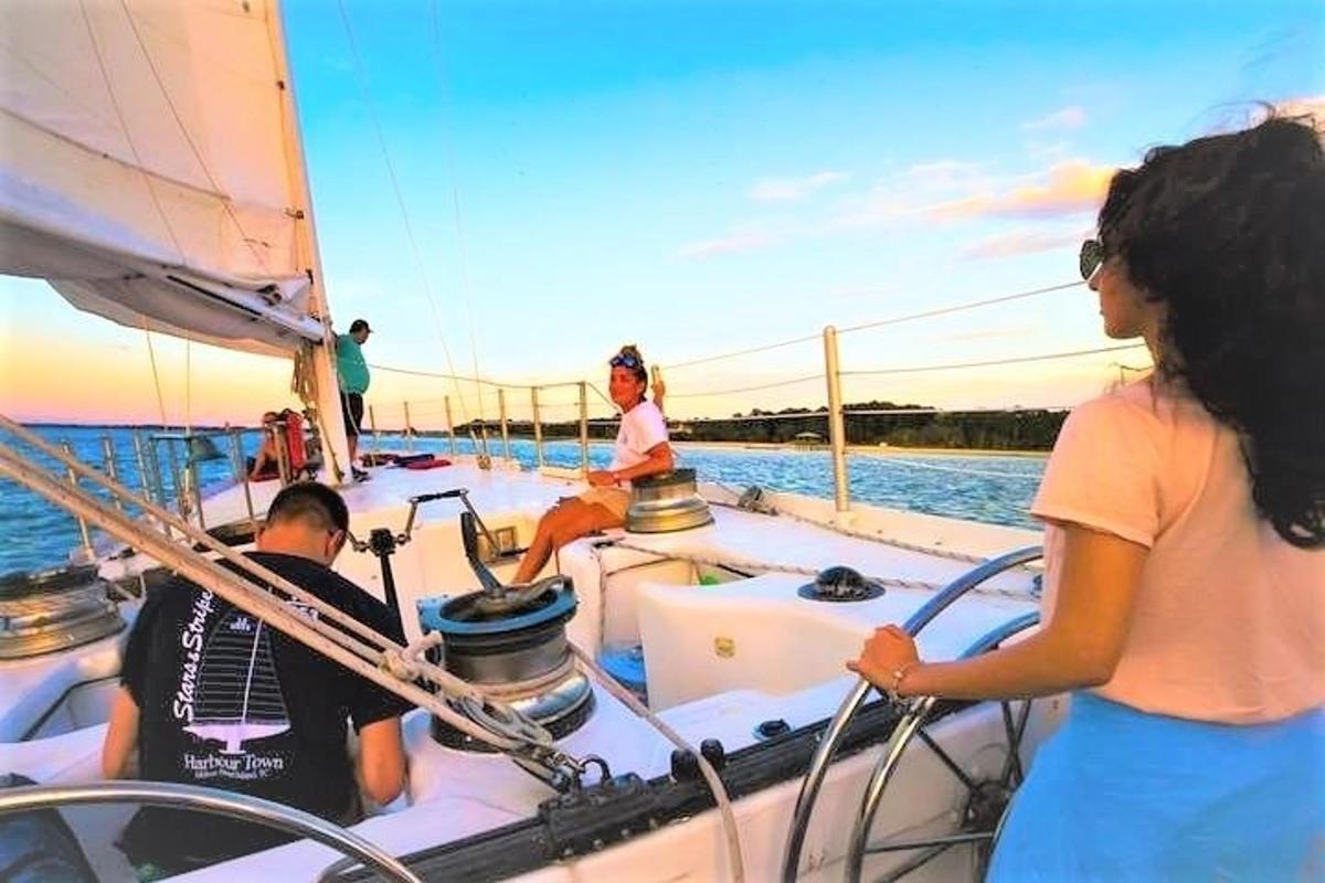 a group of people on a sailboat in the water