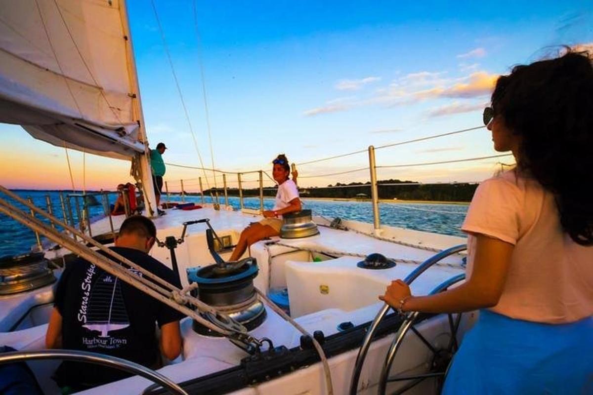 a group of people on a sailboat in the water