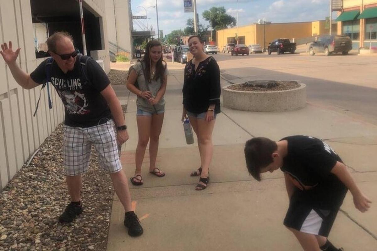 a group of people standing on a sidewalk
