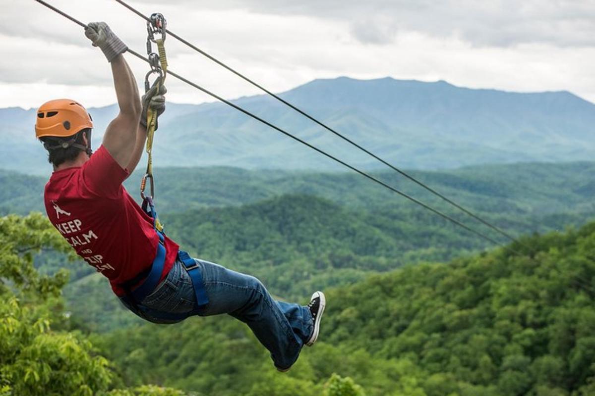 a man on a zip line in