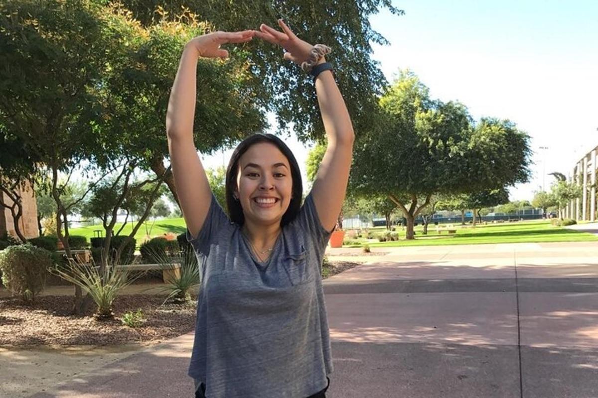 a woman standing with her hands in the air