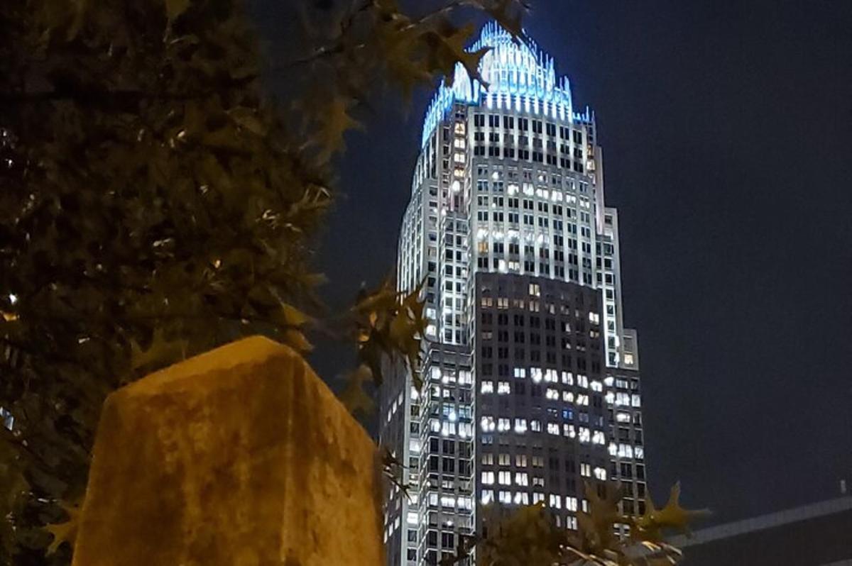 a tall building with blue lights on it at night