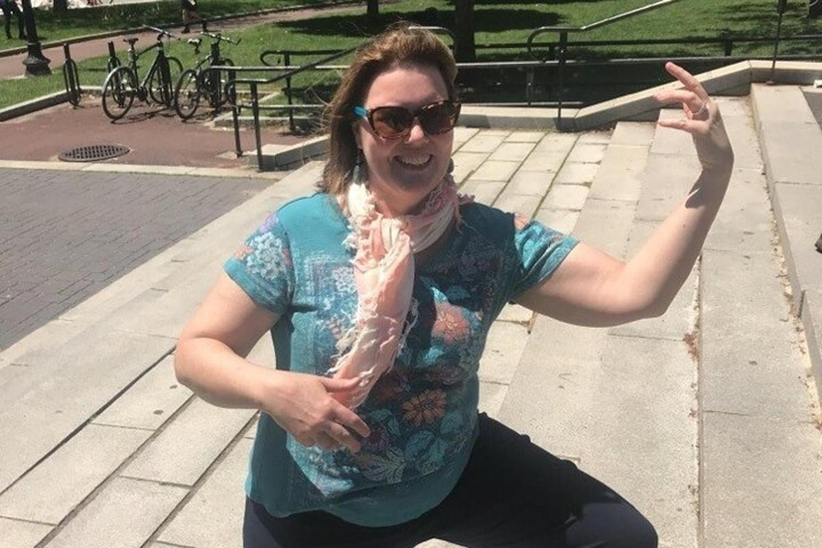 a woman in sunglasses is holding a piece of meat