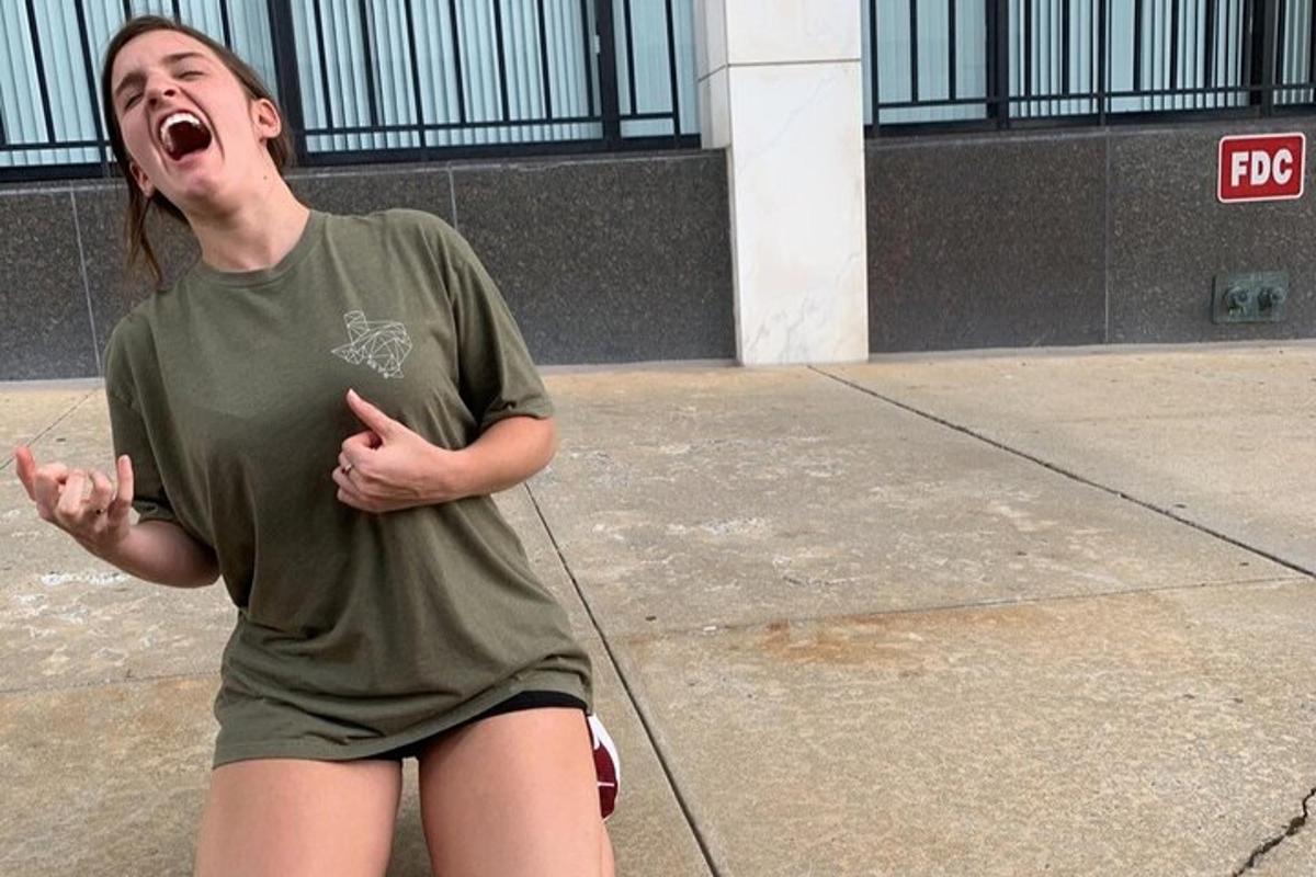 a young girl is screaming on a sidewalk
